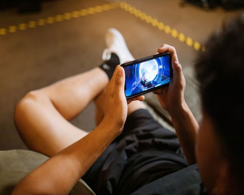 Smartphone displaying a fictional mobile game during a BattleKingdomCrown Australian gaming technology showcase